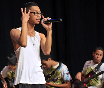 Young man doing a spoken word performance. Courtesy Partners for Youth With Disabilities.
